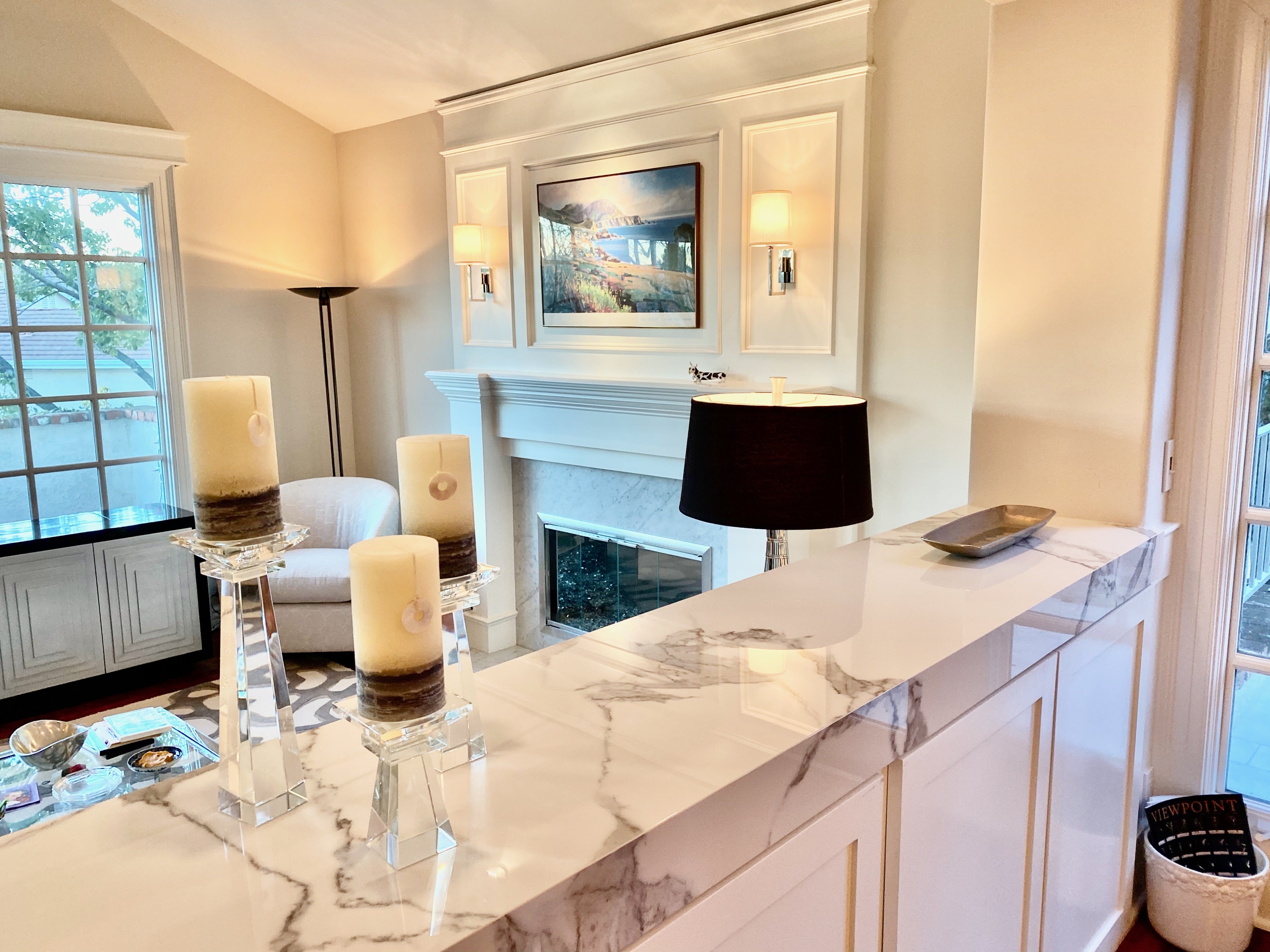 Beautiful millwork on fireplace and marble surround with custom furnishings in living room.