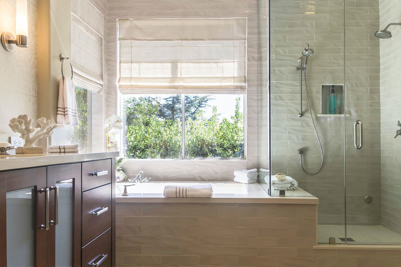 Master Bathroom with tub surround, steam shower and custom vanity with glass and wood doors.