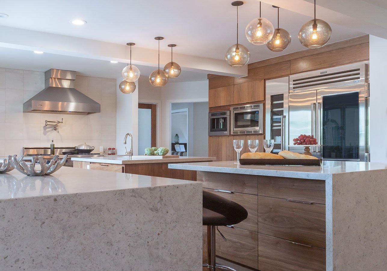 Walnut cabinets, natural stone counters and sub zero appliances.
Pendant lights.